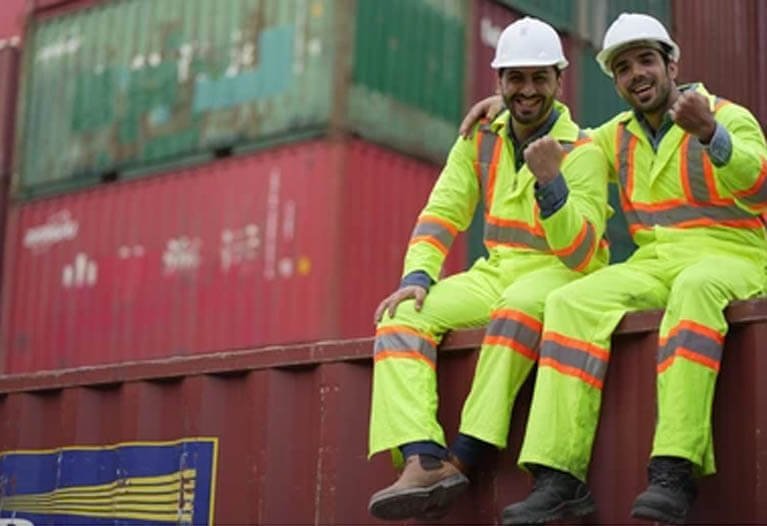 Logistics worker wearing insulated hi-vis jacket in winter shipping dock environment