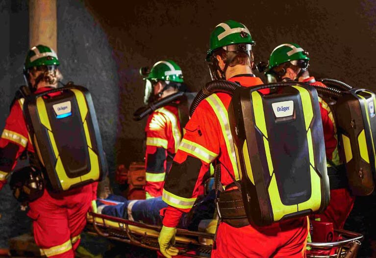 Surface mining workers in open-pit operation wearing weather-resistant hi-vis clothing